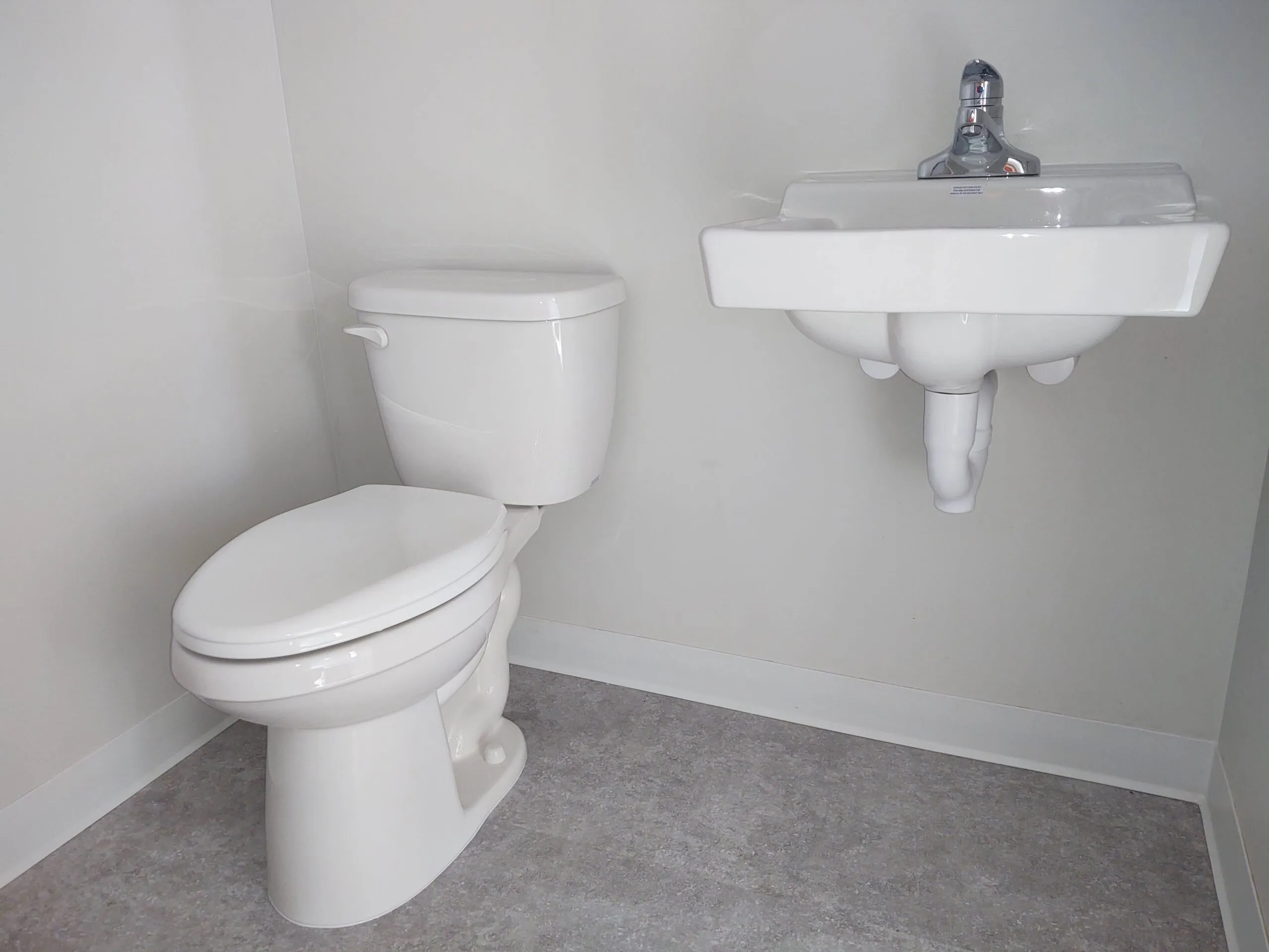 Toilet and wall hung sink in a finished commercial restroom