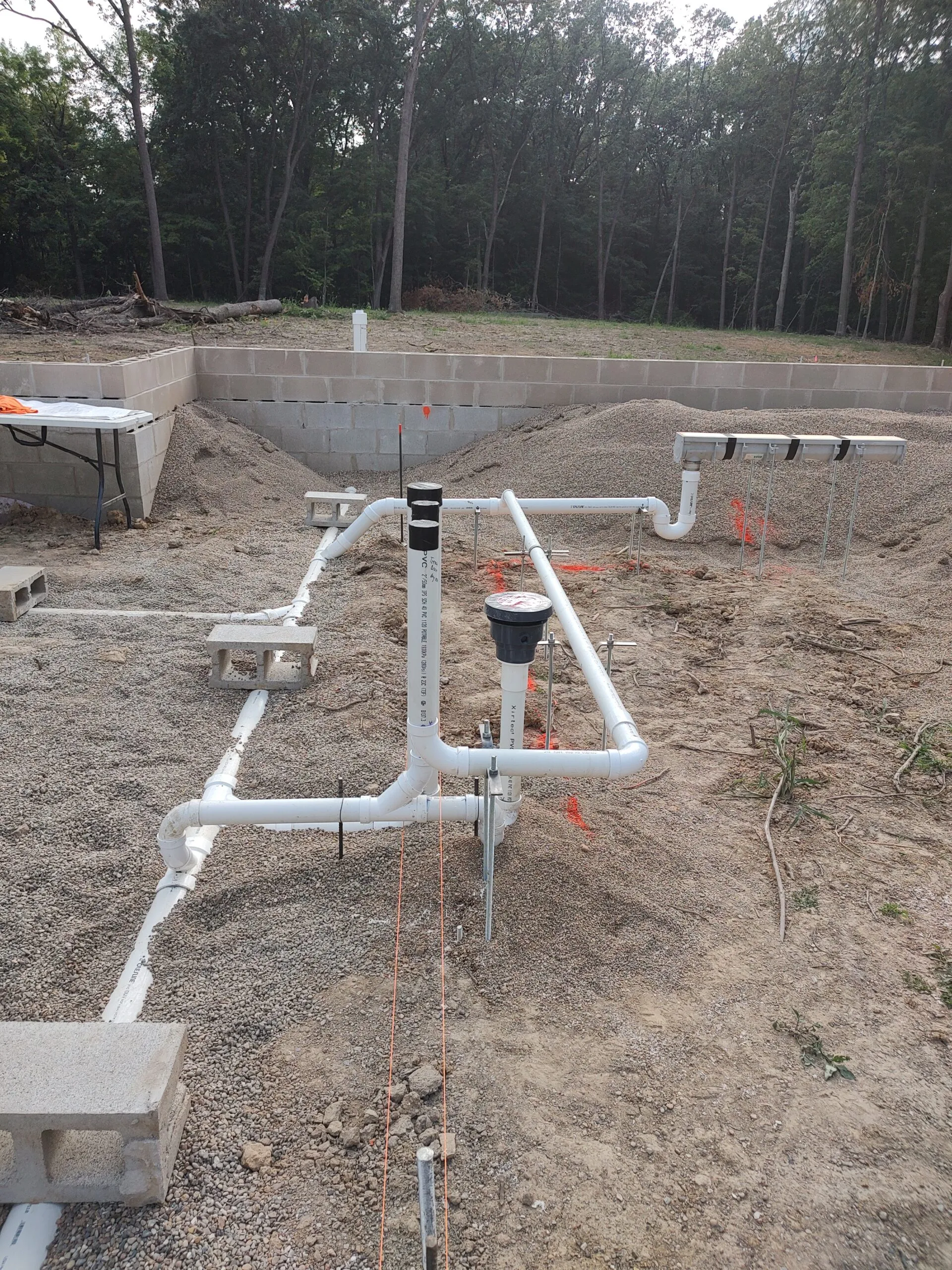 PVC drain rough-in for a walk-out basement before backfill